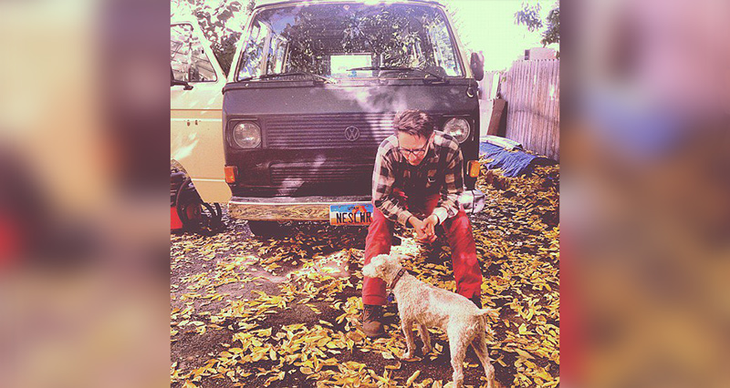 Parcel Account manager sitting on van with dog in fall