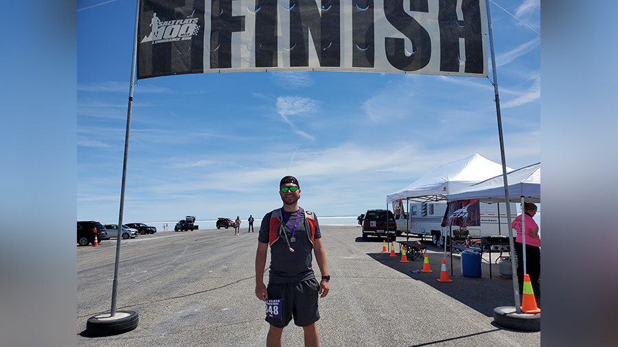 National sales manager standing at marathon finish line