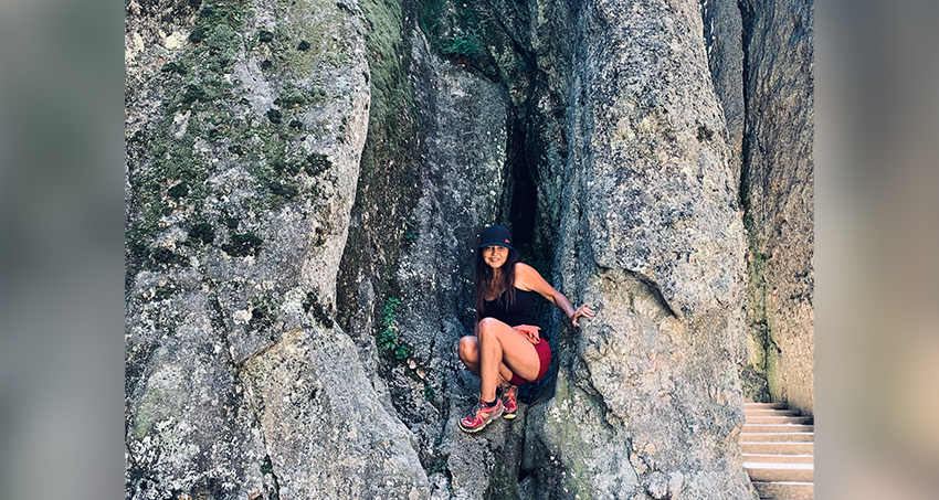 Business coach mountain hiking in rock formation